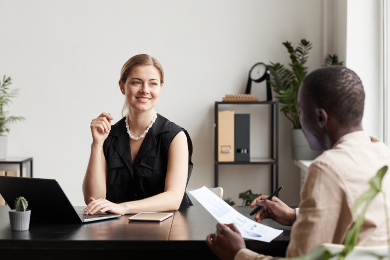 A woman and man working at a desk in the Firstbird office.