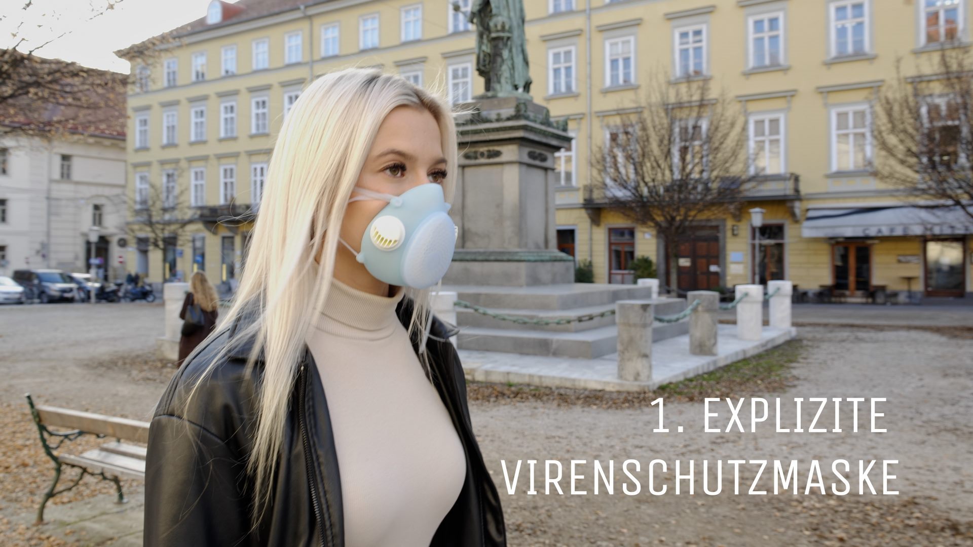 A woman wearing a Hygmask in front of a building.