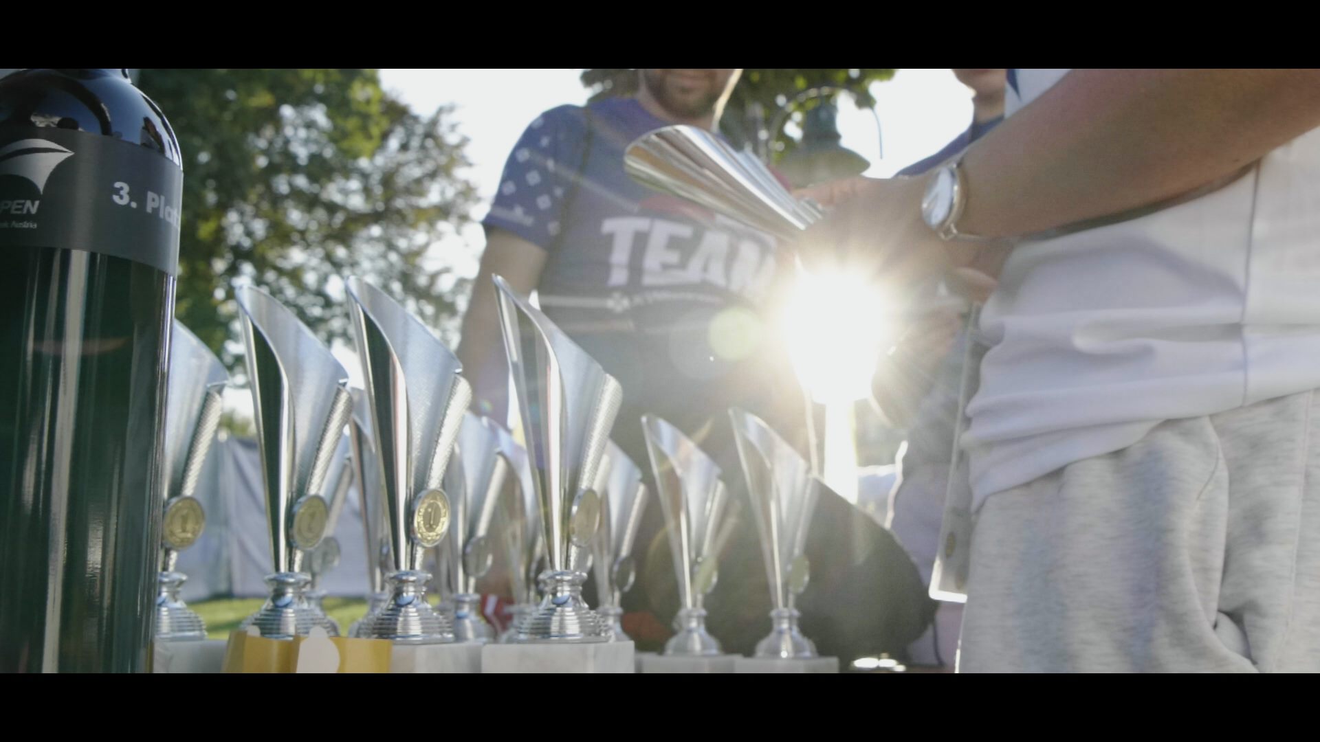 Winners of the Austria Swim Open with trophies in front of them.