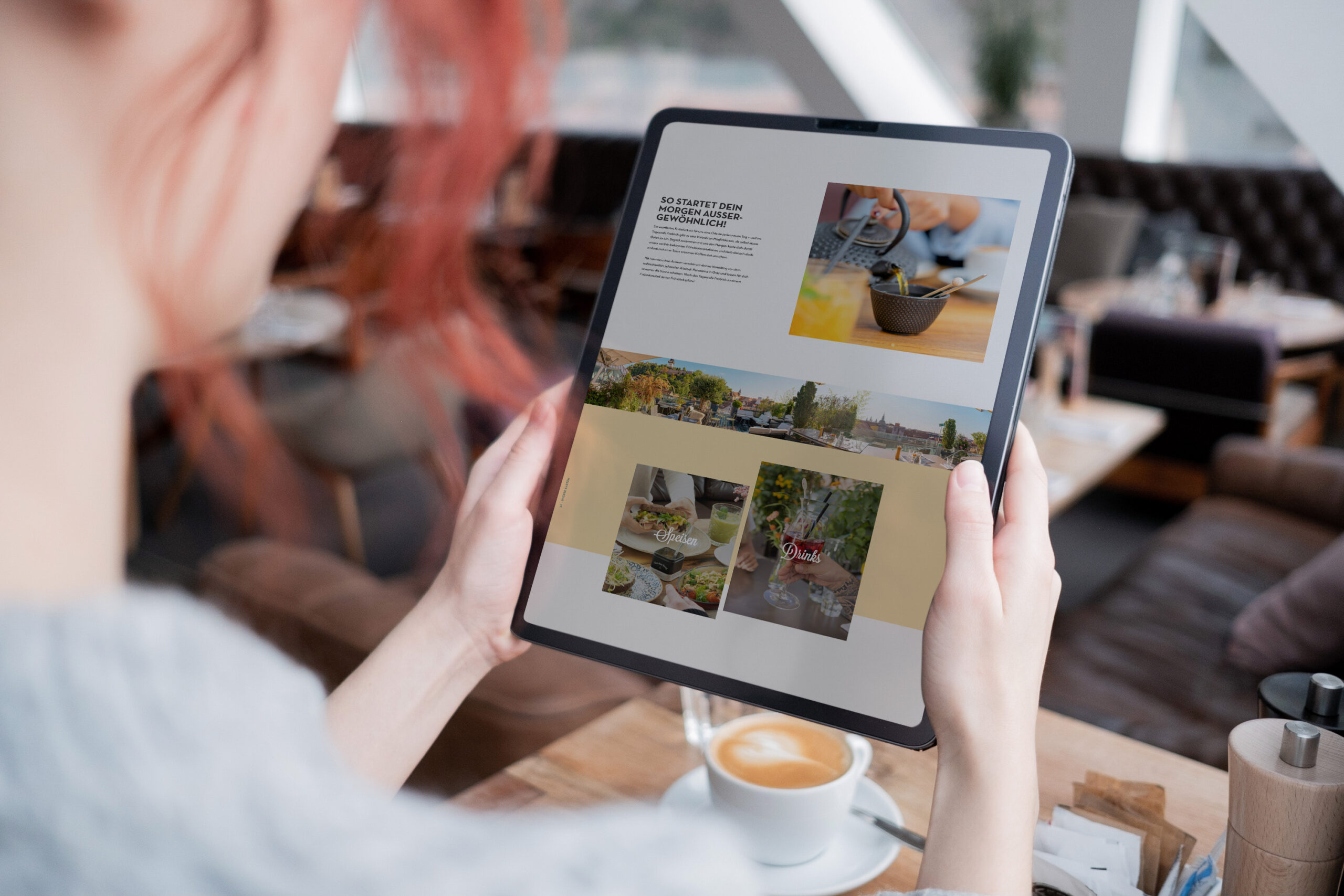 A woman using an iPad to view a website while sitting at Freiblick.