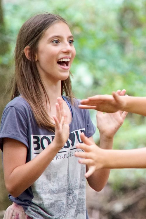 Two young champs are playing in the woods.