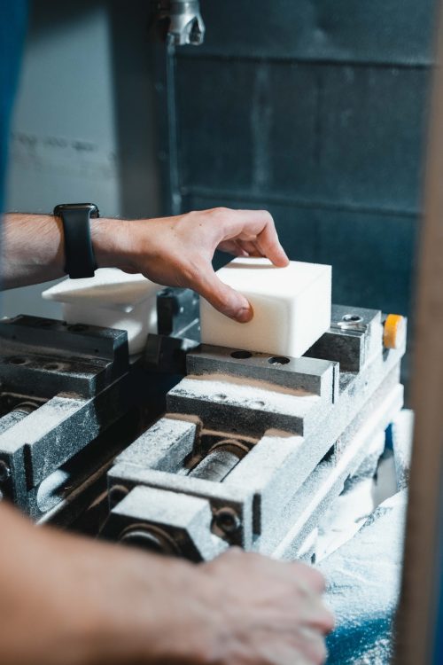 A man is working on a machine in a factory.