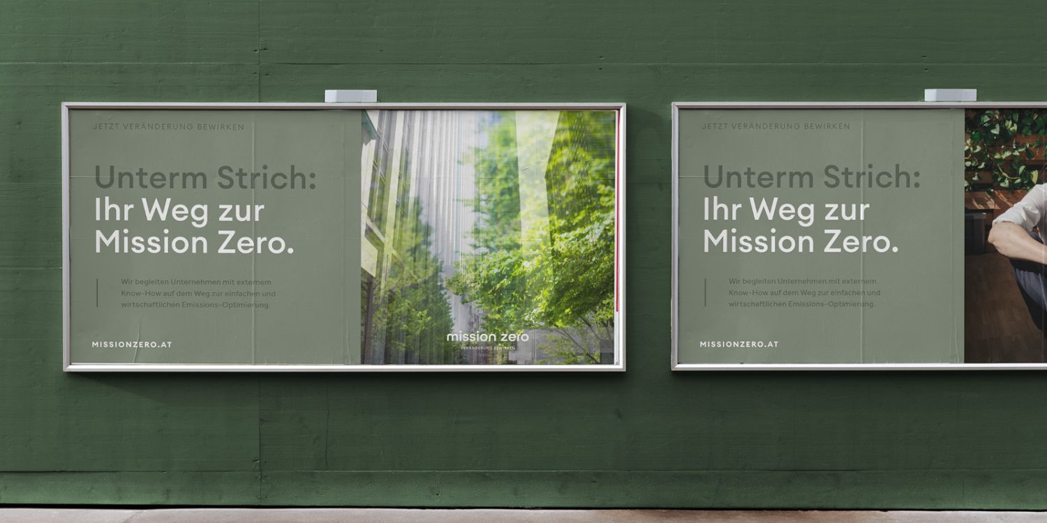 Two billboards promoting Mission Zero on the side of a green wall.