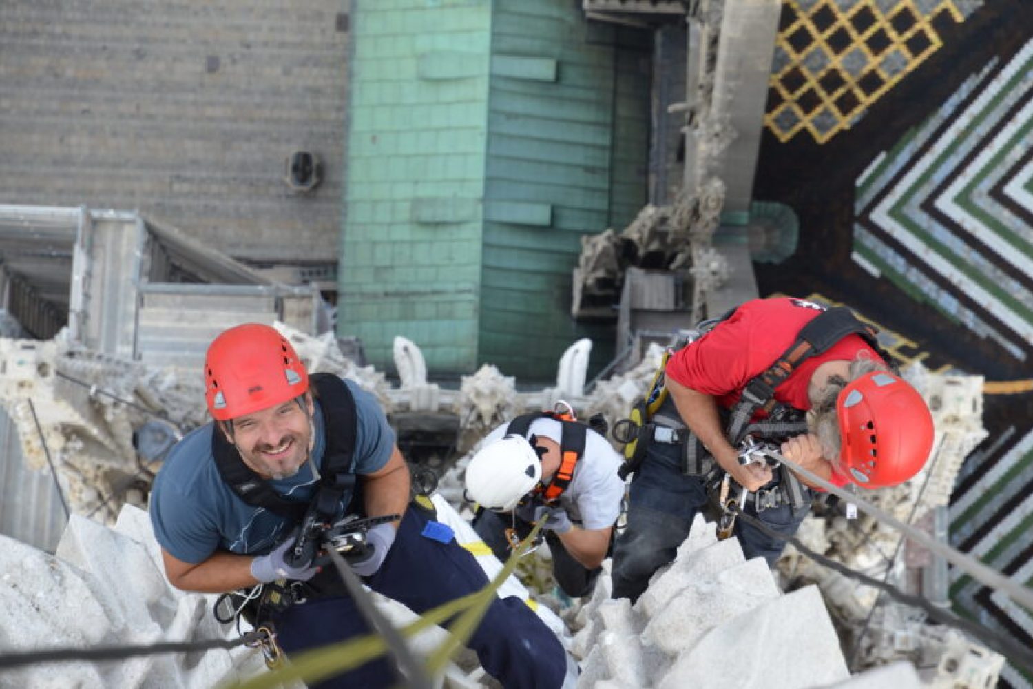 Two individuals climbing a building.