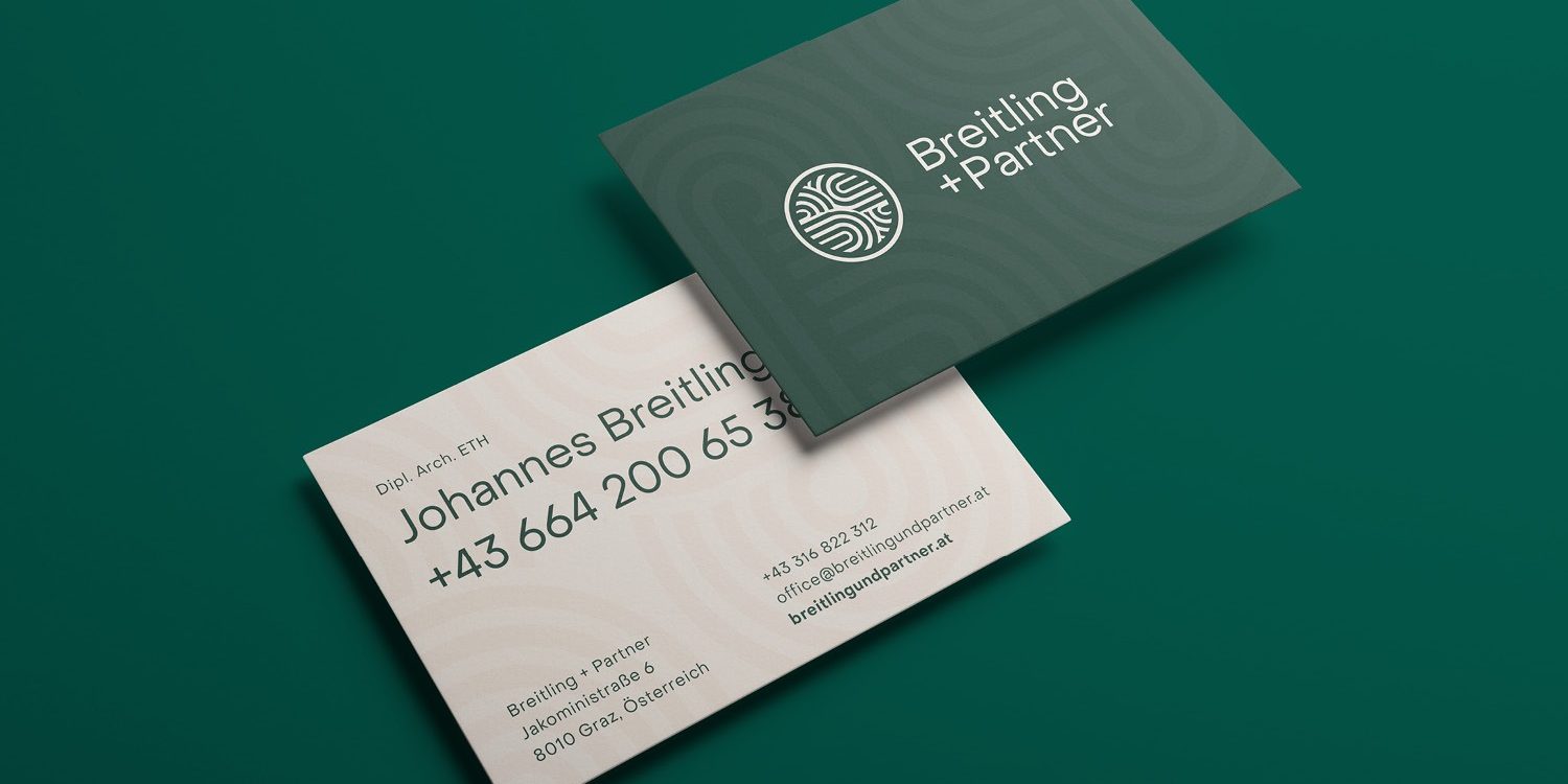 A green and white business card featuring Breitling+Partner on a green background.