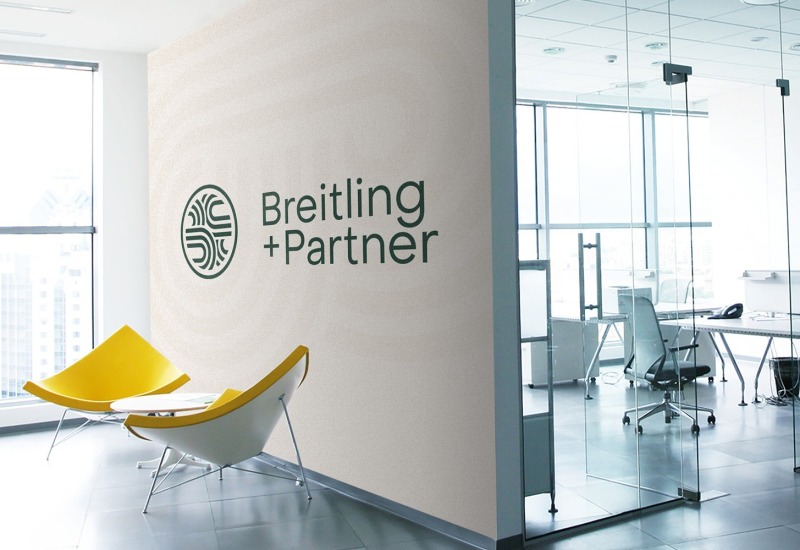 Ein Breitling-Partnerbüro mit gelbem Stuhl und Schild.