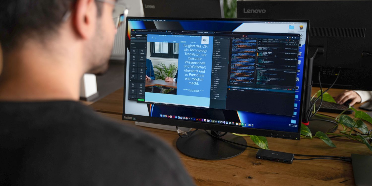 A man performing digitalization tasks at a desk with two monitors in front of him.